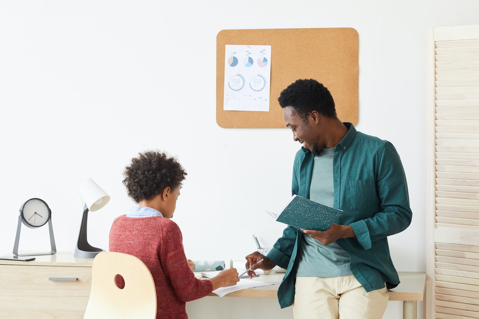 Boy studying with teacher