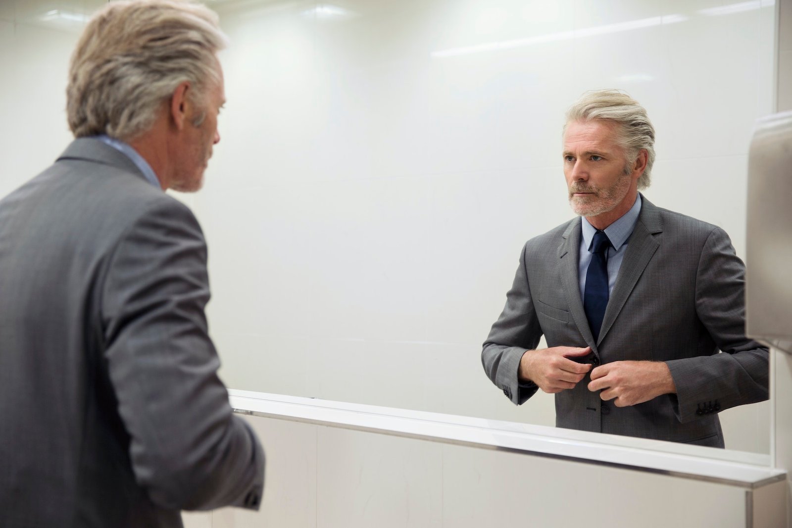 Mirror image of man looking into mirror