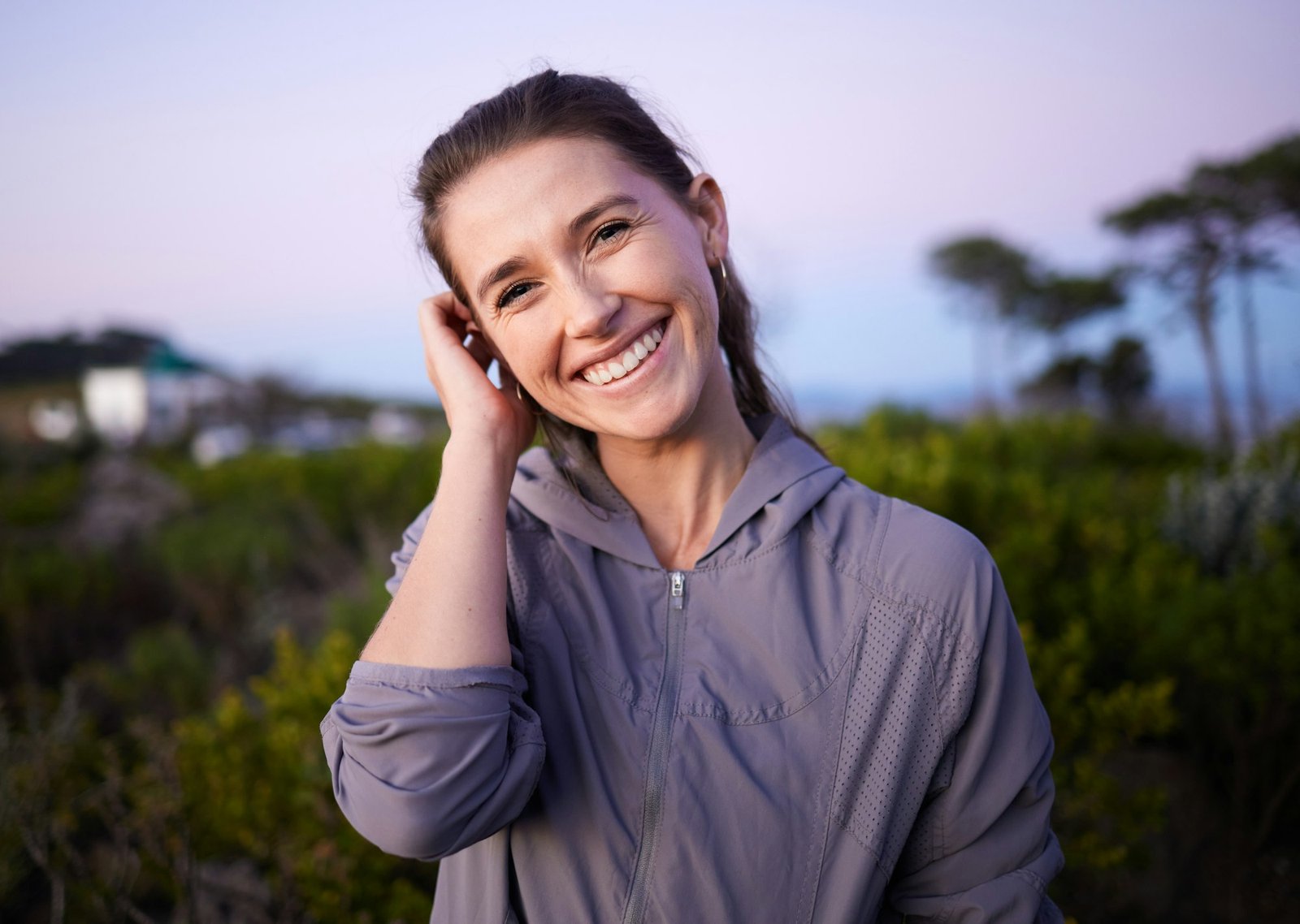 Happy, beautiful and portrait of a woman in nature during sunset for peace, calm and zen. Adventure